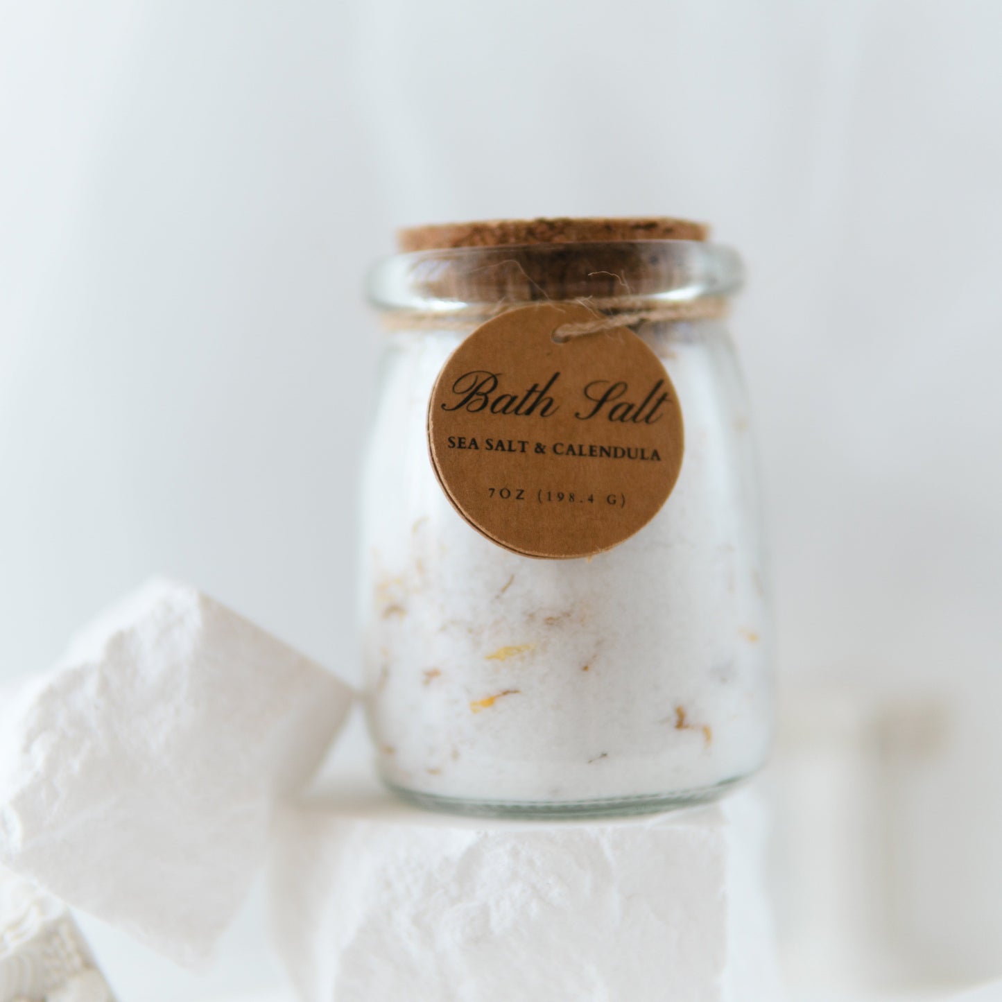 Botanical Epsom salt bath soak gift set in elegant glass jars with natural salts and dried flowers.
