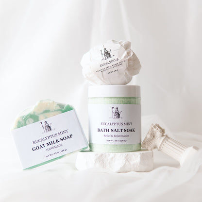 Eucalyptus Epsom Salt Bath Set with bath salts, bath bomb, and goat milk soap on a white background.