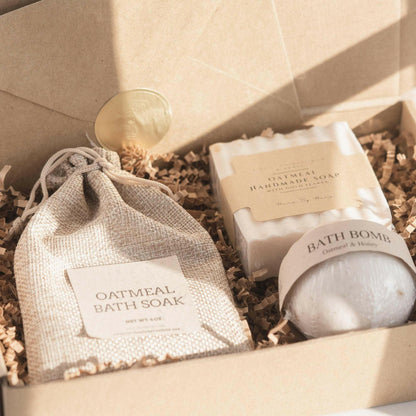 Oatmeal Milk and Honey spa gift set with bath salts, bath bomb, and handmade soap in eco-friendly packaging.